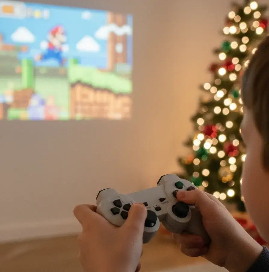 Kid playing video games with Retro Cinema projector during Christmas holidays